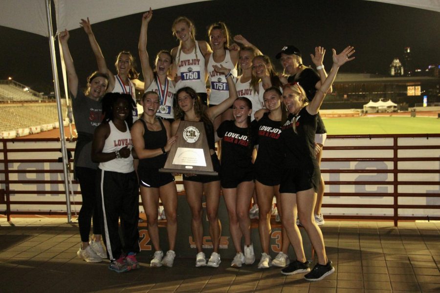 The girls track team poses with their trophy. The team placed second in the state with 48 points.