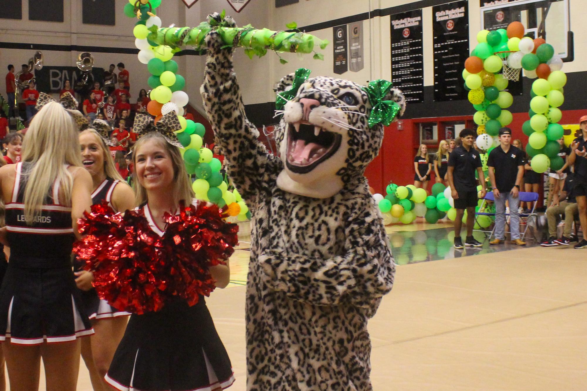 The leopard mascot holds up the spirit stick during the Leopard Battle Cry chant. The seniors won the competition.