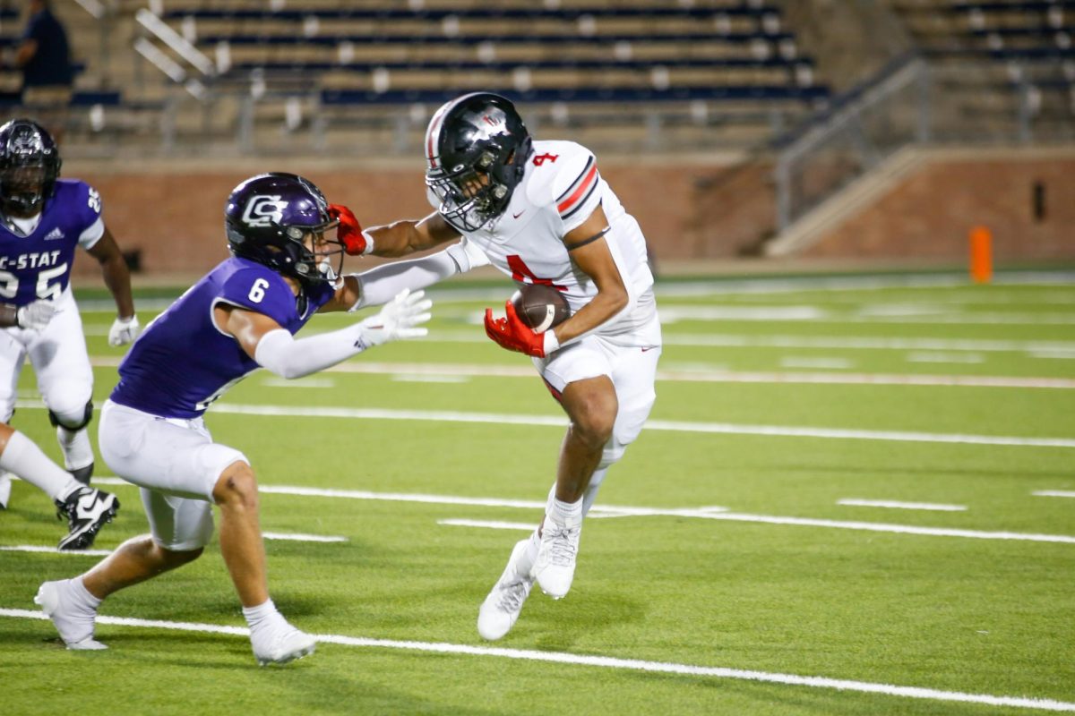 Senior running back no. 4 Dante Dean runs past a defender. The team played College Station on Saturday.