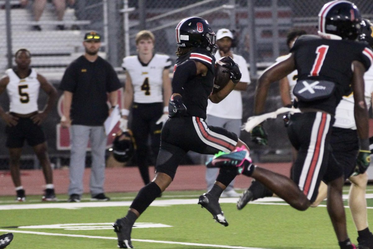 Senior running back no. 8 Khalin Williams runs the ball down the field for a touchdown. The play was during Lovejoys first possession of the game. 