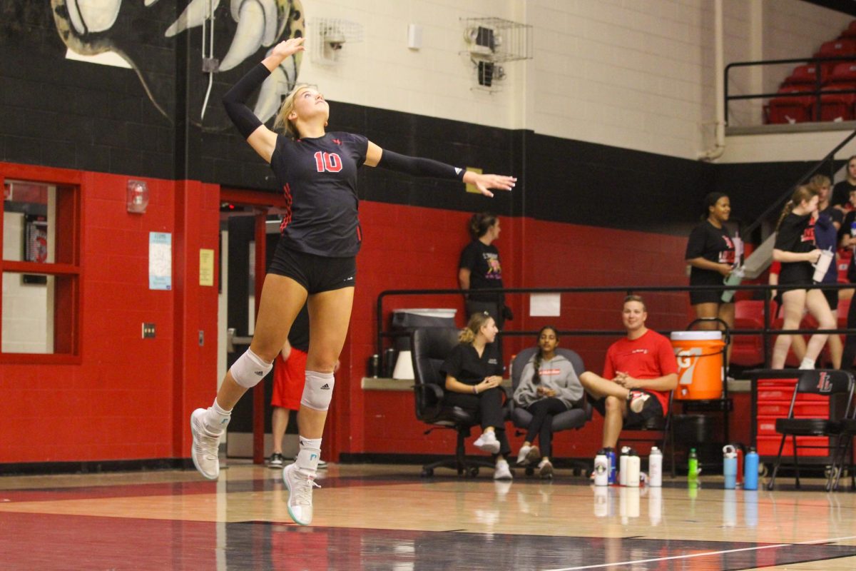 Sophomore no. 10 Skylar Jackson serves the ball. Jackson is an outside hitter.