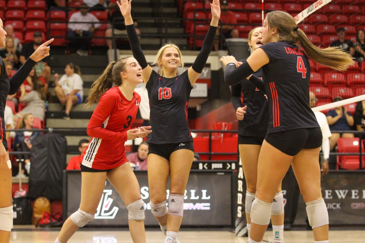 The team cheers after junior no. 4 Anna Barr has a kill. The team was playing against Mckinney North.