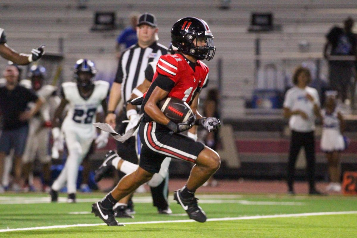 Junior running back no. 11 Daylan McCutcheon runs the ball. The team had 80 rushing yards.