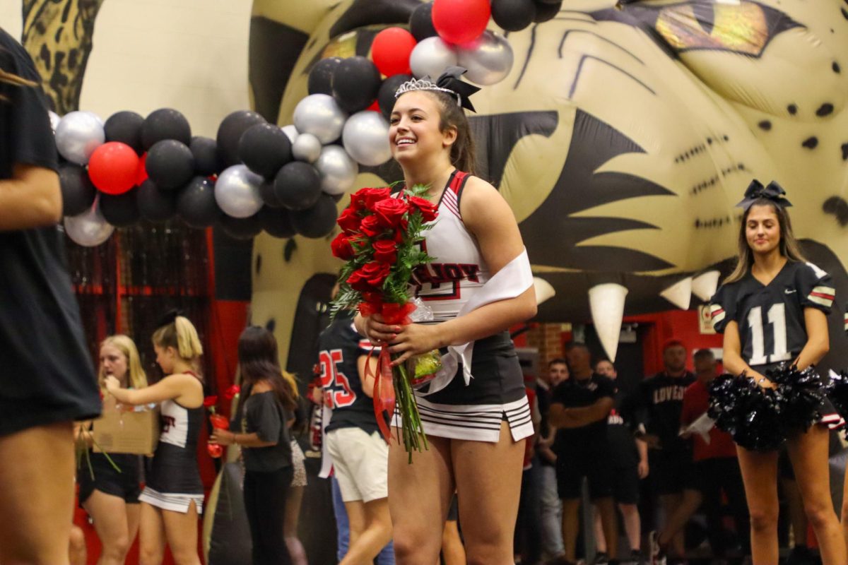 Freshman Carson Fox smiles after being awarded Freshman Lady. Fox is apart of the Cheer and Track teams at Lovejoy.