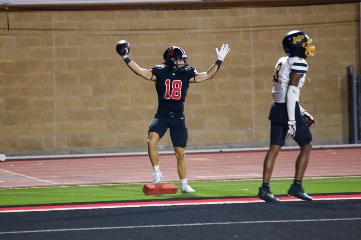Senior wide receiver no. 18 Ethan Nelson signals for his touchdown to be called in the Lovejoy endzone. Lovejoy scored 7 touchdowns. 