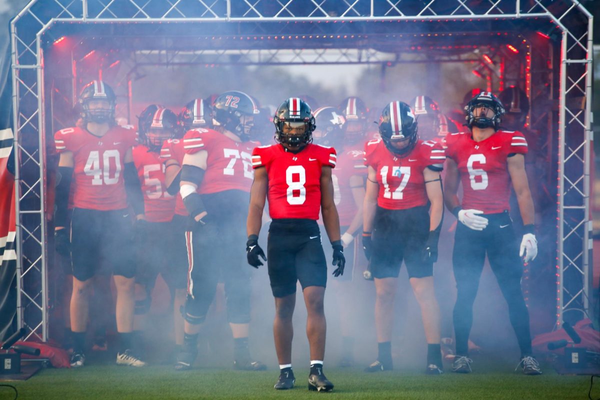 Senior running back no. 8 Khalin WIlliams leads the team out of the tunnel. The game was delayed by rain.