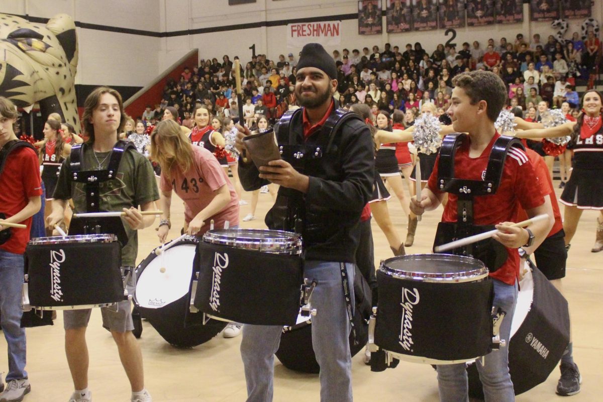 Senior Anup Ghumman leads the cowbell at the pep rally. It is performed at every pep rally.