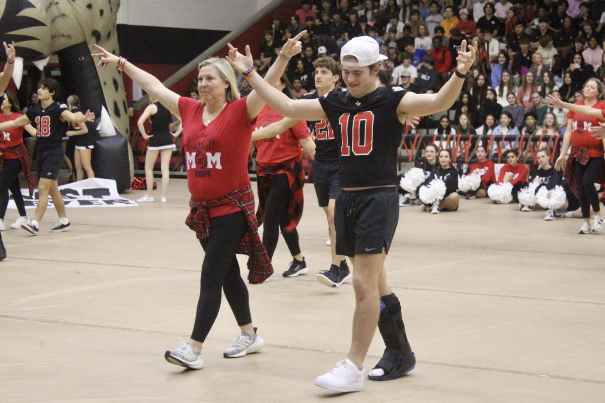 Senior Alexander Franklin and his mom dance at the pep rally.  The dance was all of the senior football players and their moms.