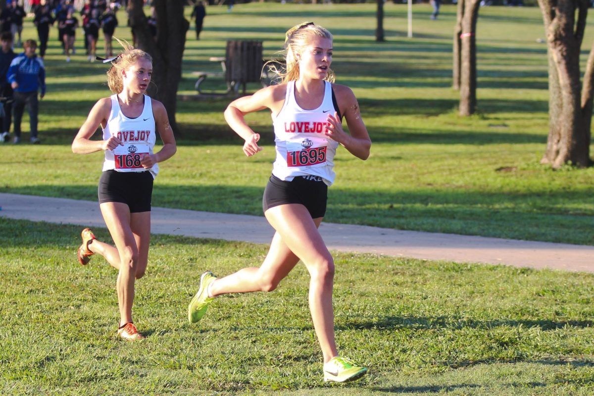 Senior Sara Morefield and Sophomore Camryn Benson race with each other.  The two girls finished withen a second of one another.