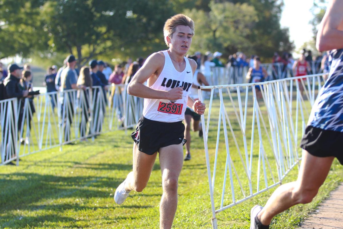 Junior Caden Gary hits the 2 mile mark for the 5k race. Gary placed 14th with a time of 15:46.60.