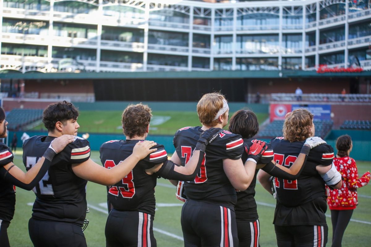 Seniors Brandon Monroe, Jayce Pointer, Will Fry, and junior Owen Magee show their respect during the national anthem. The game was played at Choctaw stadium in Arlington.