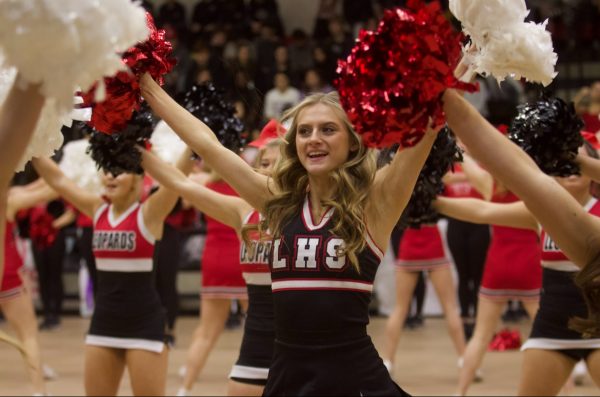 Senior Alexis Lambert cheers at Fridays pep rally. The theme was rock and roll.