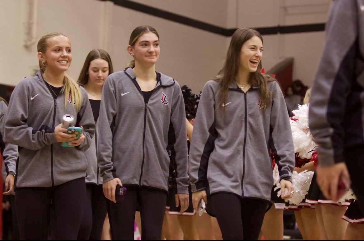 Junior Breeana Hoffman, junior Aeva Haas, and senior Lauren Dolberry walk out to the pep rally. They walked out with the rest of the Girls Varsity Basketball team.