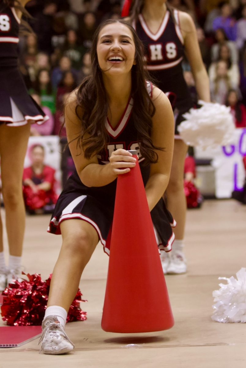 Senior Ava Hempkins cheers with the team. The cheerleaders performed the chant at this years State competition.