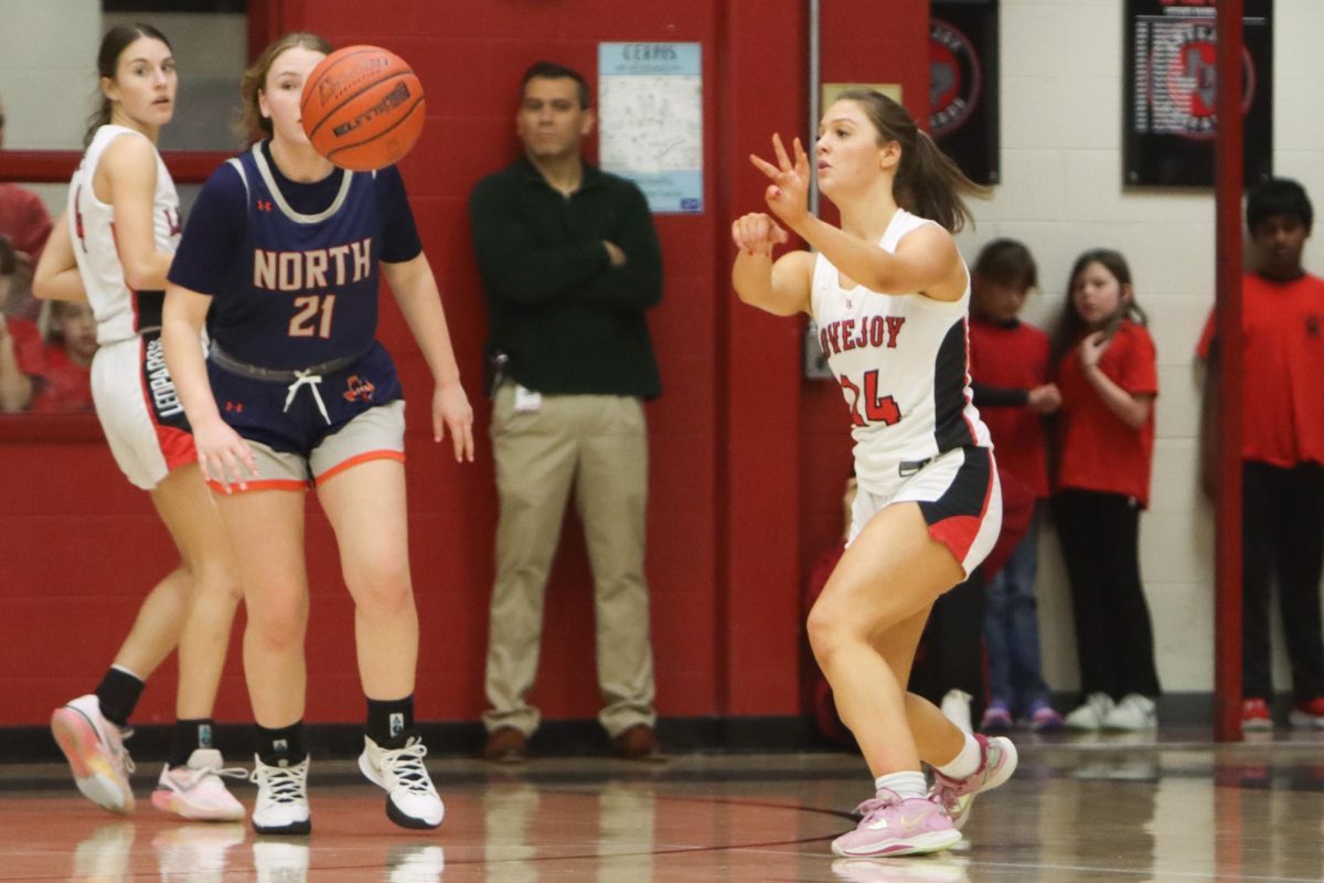 Junior no. 14 Lexi Galloway passes the ball away. Last year Galloway averaged 1.2 rebounds per game.