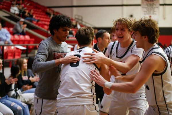 Teammates celebrate with senior no. 3 Sawyer black after he is fouled after a made basket. The game was against Sherman.