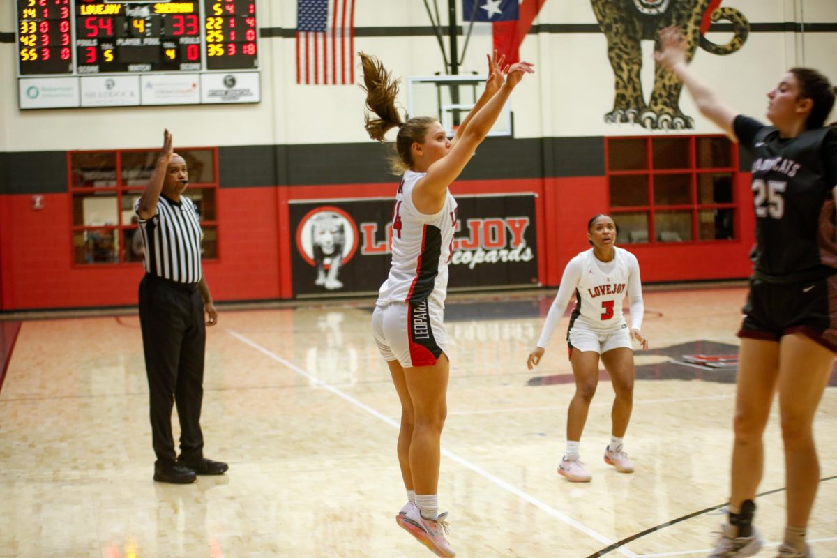 Junior guard no. 14 Lexi Galloway shoots a three pointer. Lovejoy played at Denison on Friday.