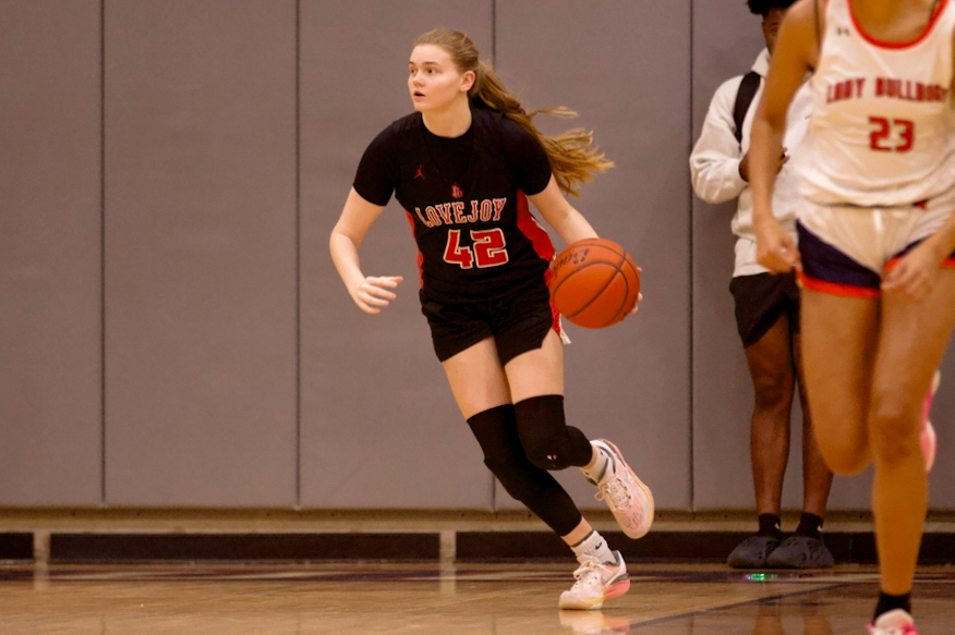 Sophomore no. 42 Peyton Novicke dribbles the ball up the court. This is Novickes second year on the Varsity team.