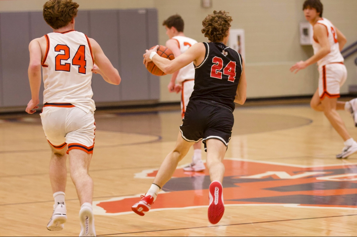 Senior no. 24 Ryan Rogers takes the ball up the court. The team will play Melissa on Friday.