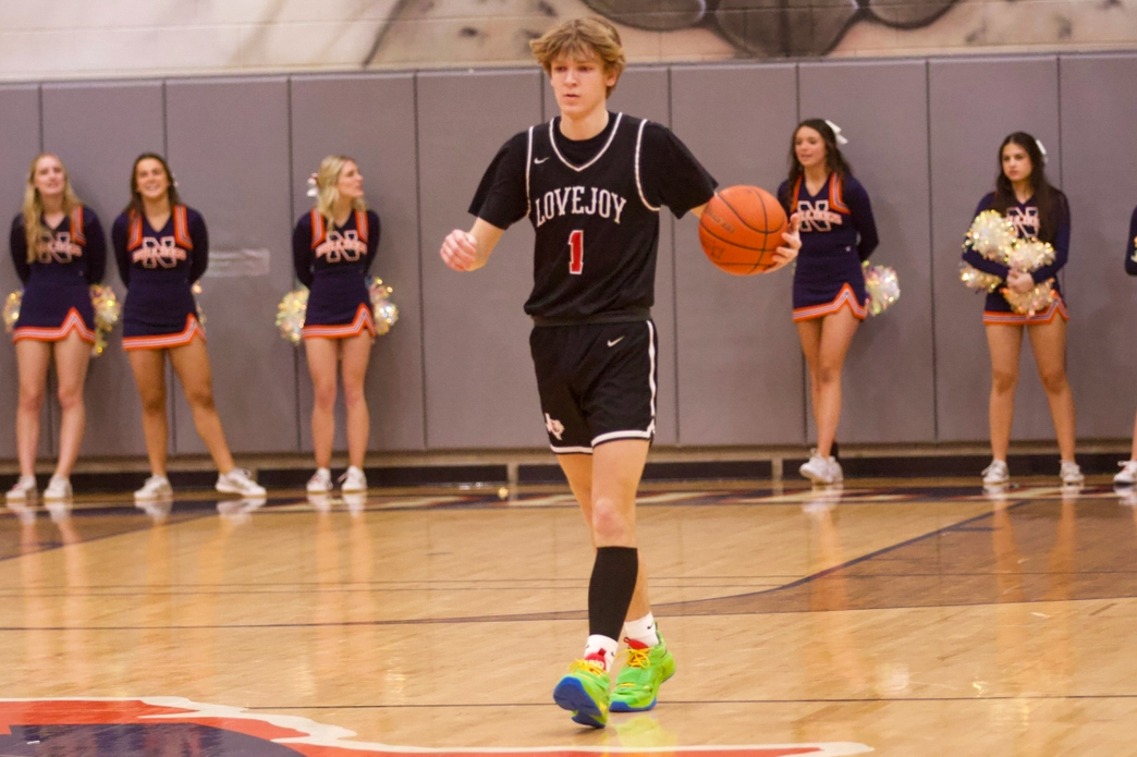 Junior no. 1 Tate Ziemkiewicz dribbles the ball up the court. The next home game is on Feb. 13 against Greenville. 