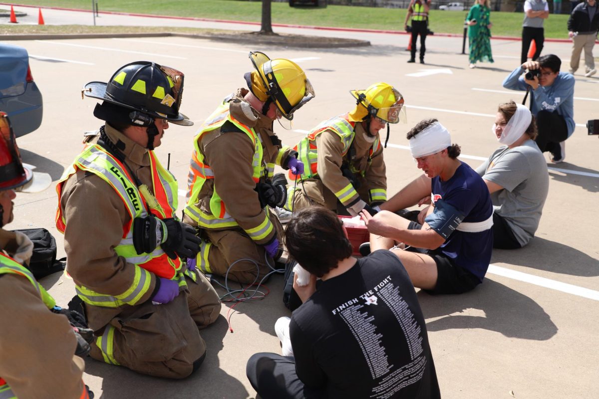First responders take procedures to take care of three passengers. The simulation was for juniors and seniors.
