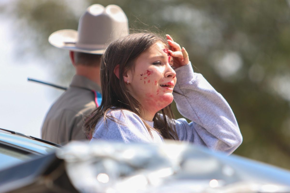 Junior Izzy Joyner stands outside of the car after the crash.“We really want to get the message across that the decisions that passengers make while they ride in a car has a tremendous impact on injury prevention,” says Contreras. “We also want the students to understand their personal responsibility and opportunity to make good choices while they are driving.”, The director of shattered dreams.