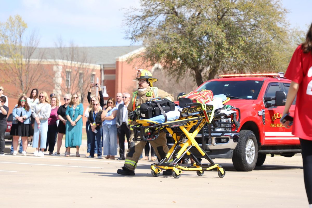 A firefighter brings the stretcher over to the crash. the event took place yesterday during 5th and 6th period.