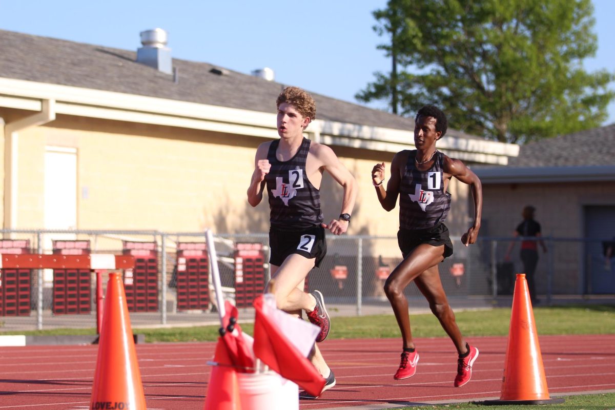 Juniors Ethan Murray and EJ Morrow fight for their last 300 of the 800 meter JV race. Murray and Morrow placed 1st and 2nd at the District meet.