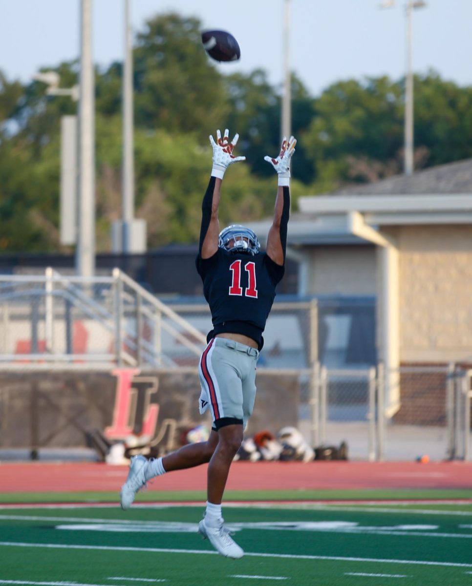 Senior wide receiver no. 11 Daylan McCutcheon catches a pass. McCutcheon is committed to Florida State University.