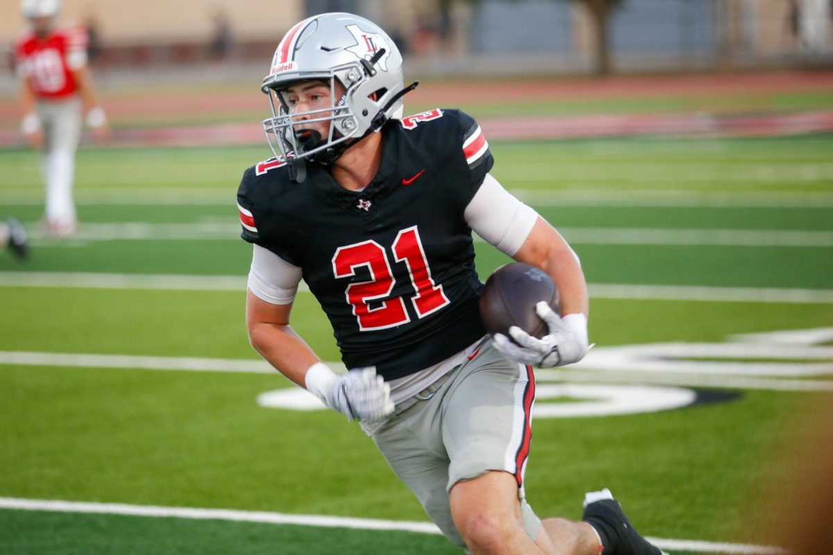 Junior wide receiver no. 21 Brody Speiran runs the ball. Lovejoy's head coach is Tod Dodge.