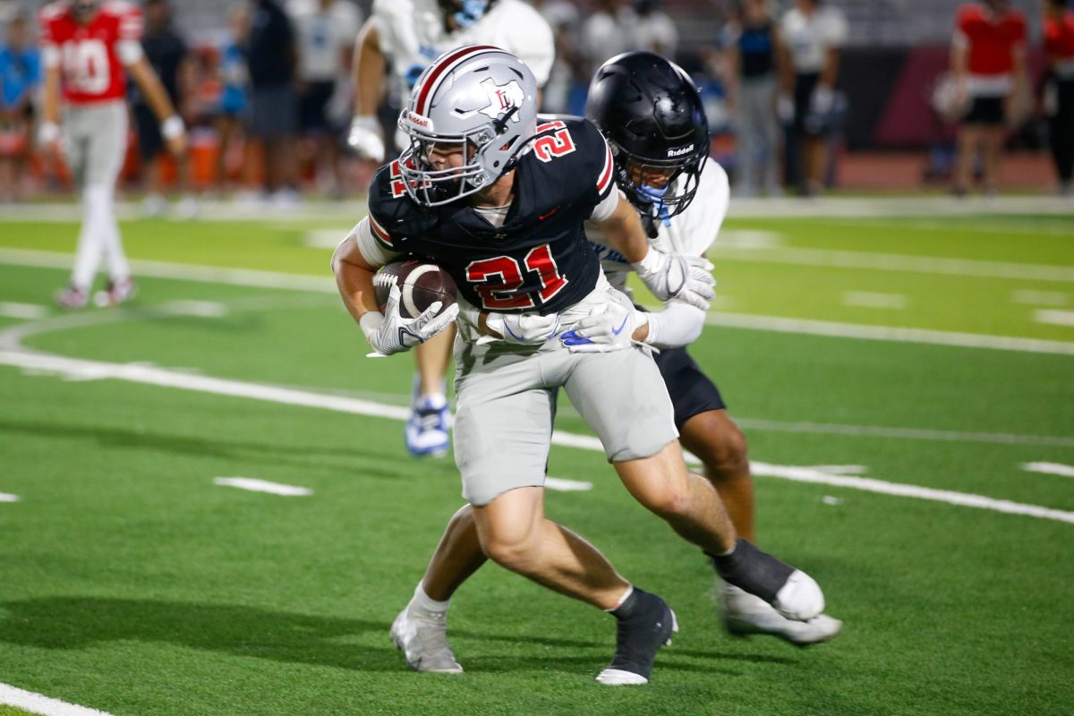 Junior wide receiver no. 21 Brody Speiran avoids a tackle. The team lost to South Oak Clif to end last season