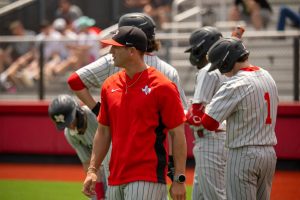 Head baseball coach Ryan Gros looks out at the field during a district game. Gros promotes day-to-day actions, instead of results.