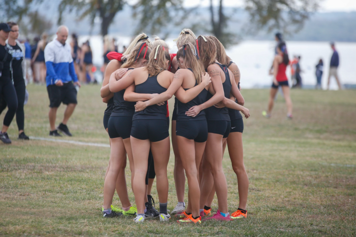 The girls cross country team prays in huddle before their race. They went on to win regionals and qualify for state.