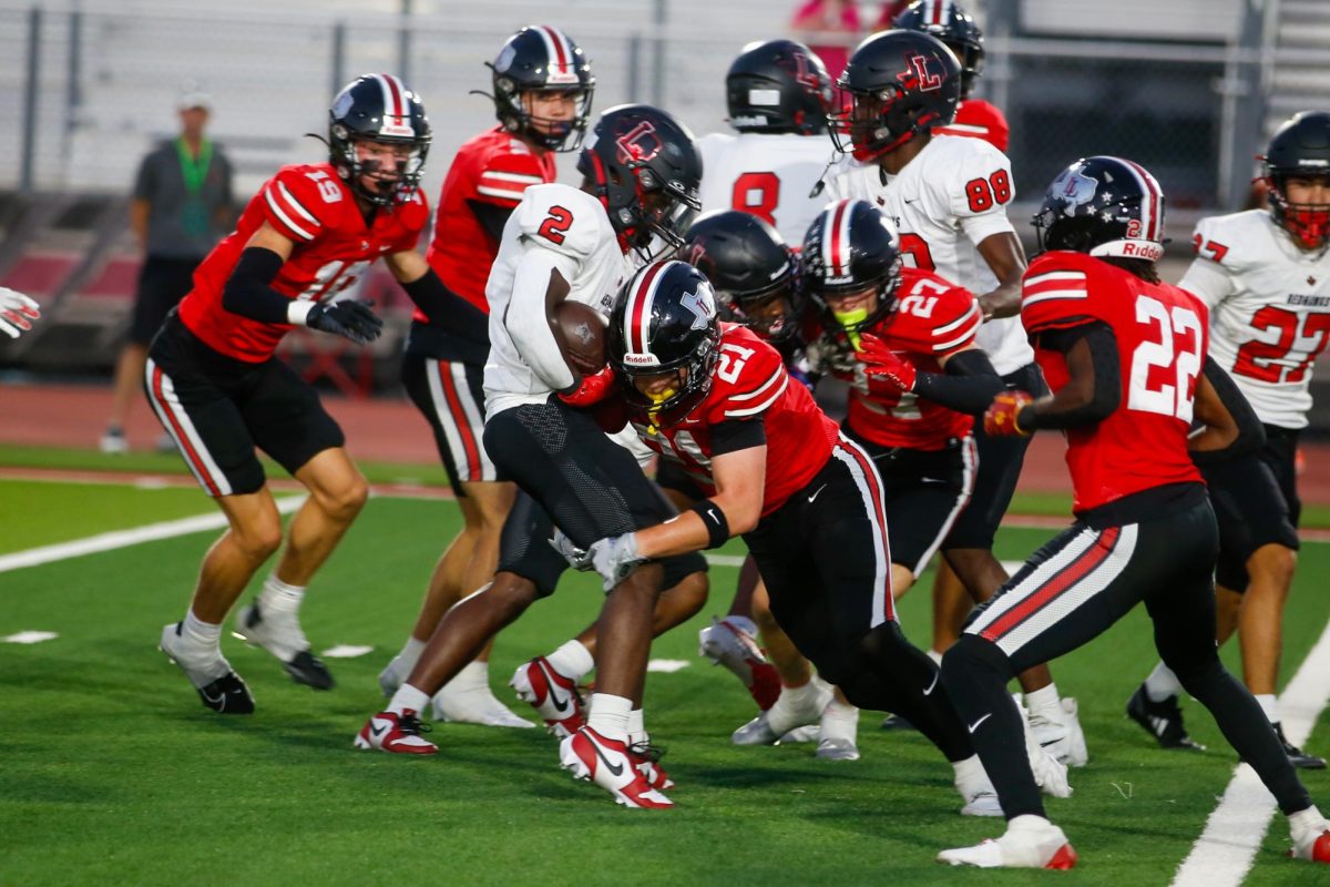 Junior wide receiver no. 21 Brody Speiran tackles a Liberty player. Lovejoy is currently 1-2.