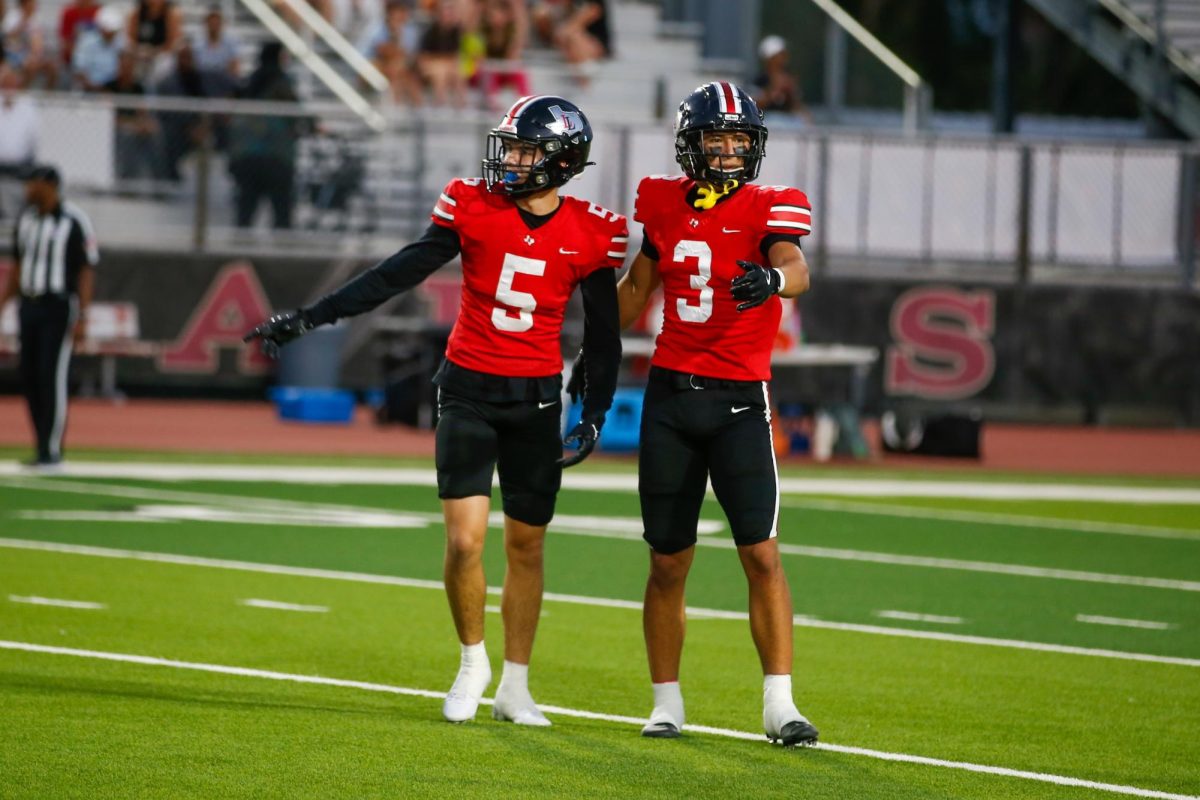 Senior corner no. 3 RJ McIntosh shows junior corner no. 5 Beyer Toyooka where to line up. The theme was red out.