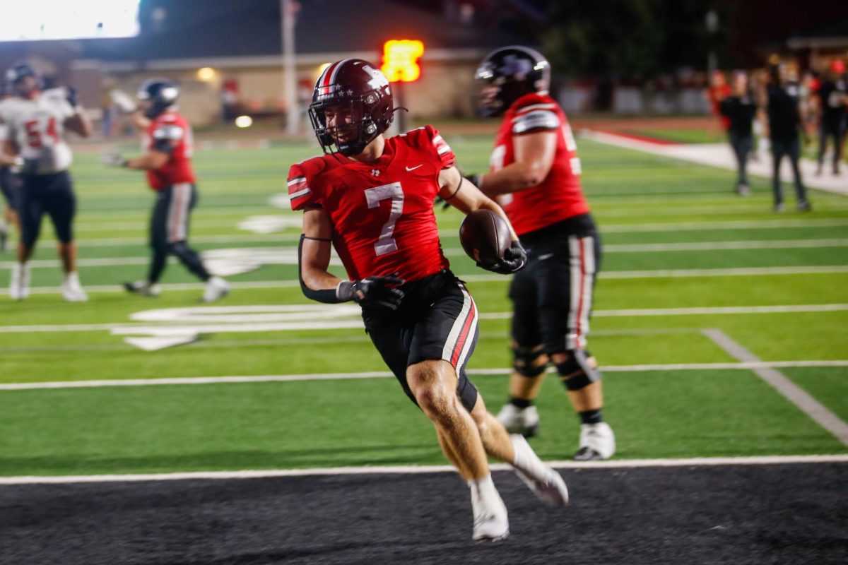 Senior running back no. 7 Ben Adams runs the ball into the end zone. Lovejoy plays against Anna next Friday.