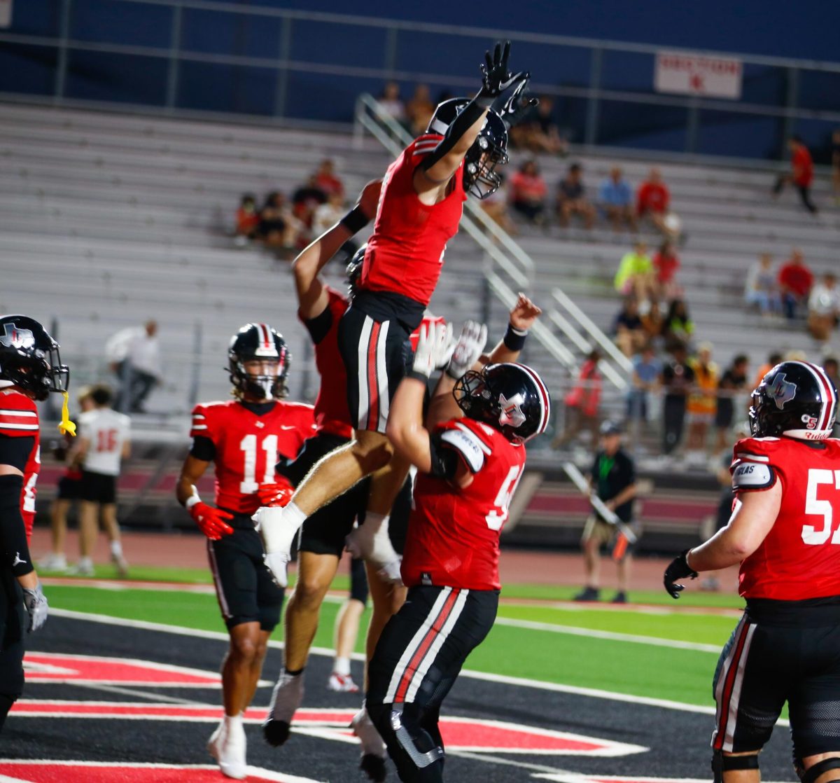 Senior guard no. 54 Braedon Gibson lifts Senior running back no. 7 Ben Adams to celebrate a touchdown. Lovejoy won 76-0.