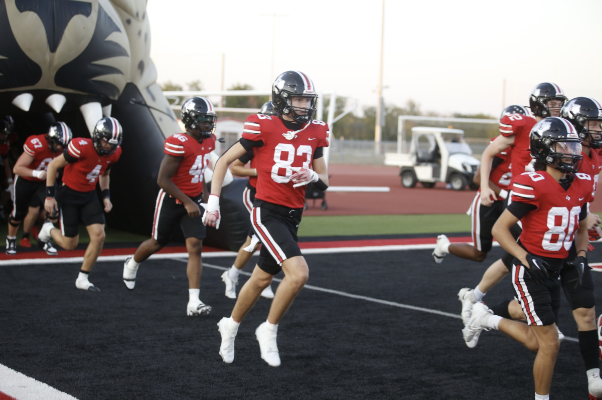 Coleman Reaugh runs out of the leopard head at the beginning of Liberty game. He is number 83.