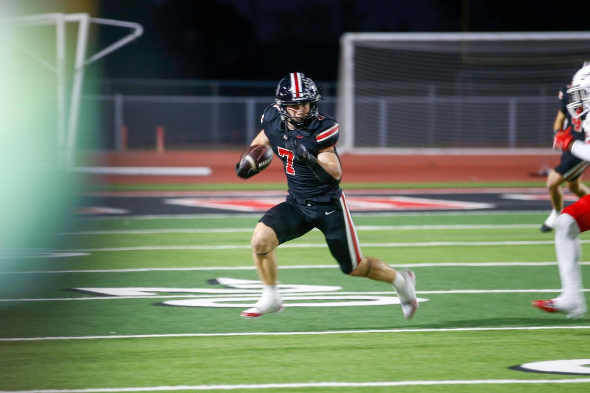 Senior running back no. 7 Ben Adams runs the ball. Lovejoy is 3-0 in district play.