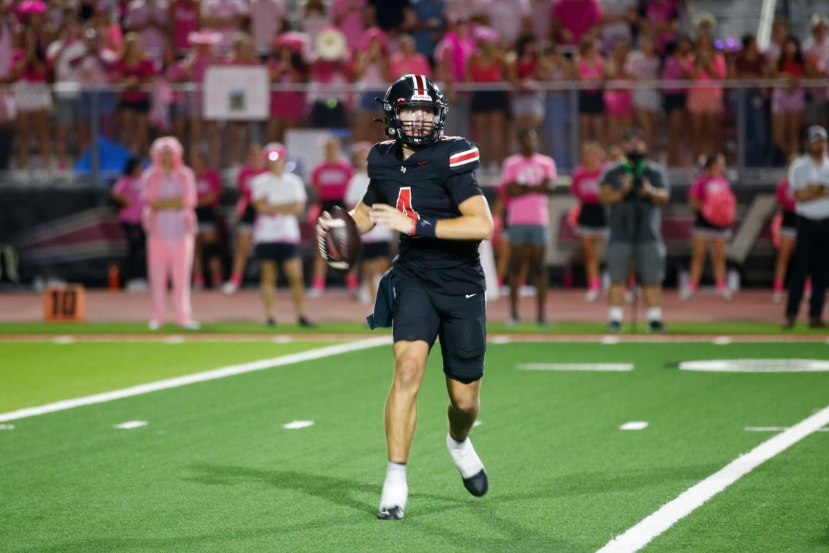 Junior quarterback no. 4 Jacob Janecek prepares to pass the ball. The theme for the game was animal print.