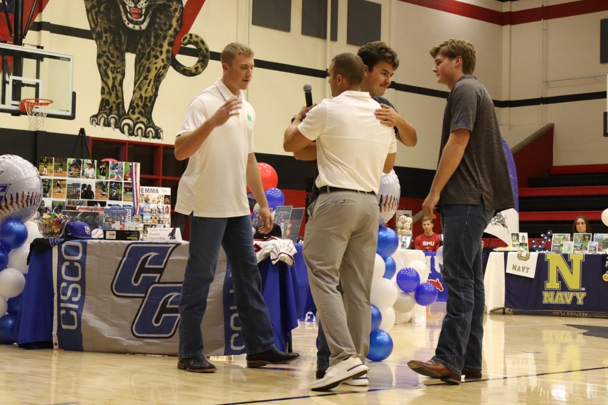 Senior Parker McGrael hugs head varsity baseball coach Ryan Gros. McGrael signed to Cisco College.