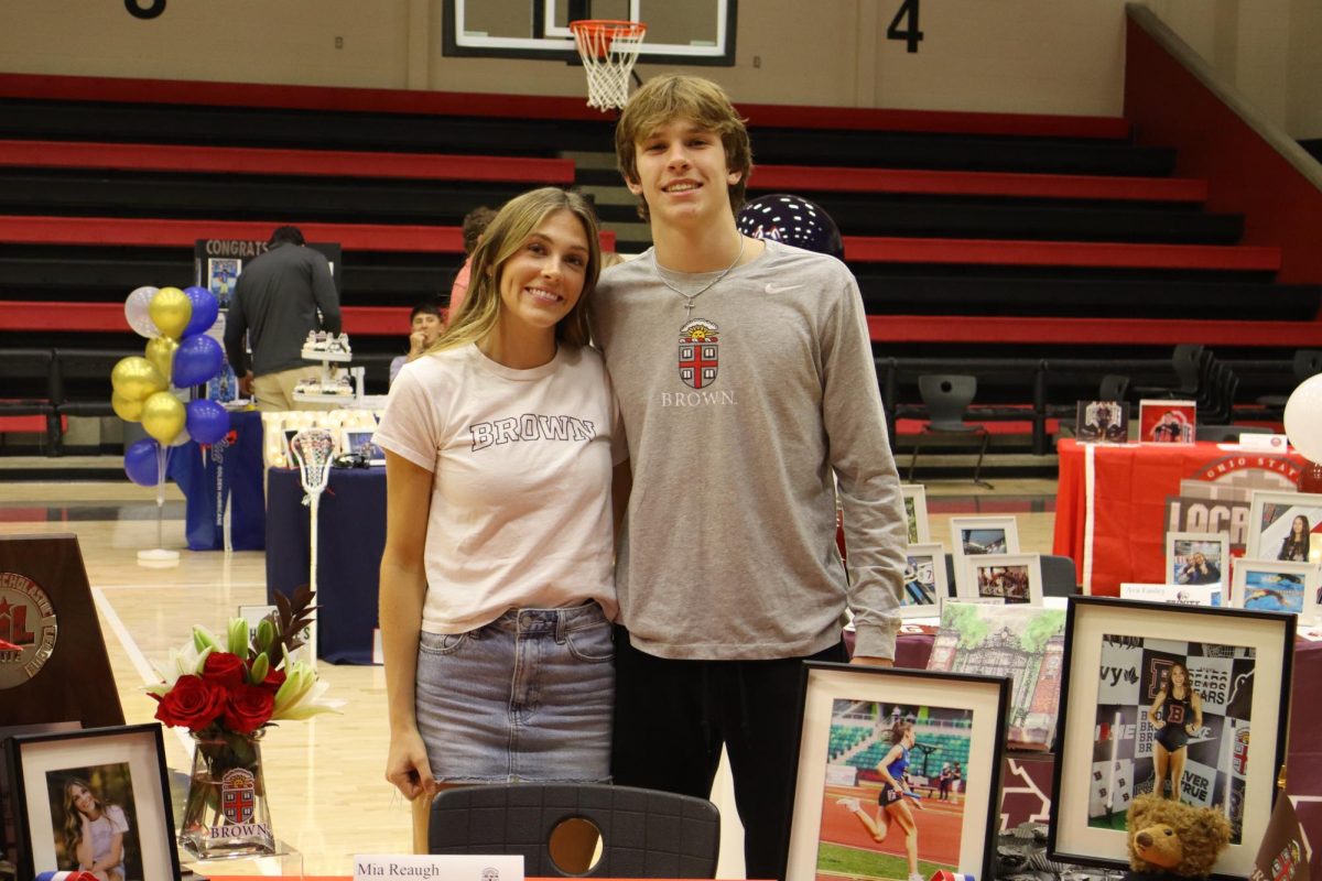 Senior Mia Reaugh poses with her brother freshman Coleman Reaugh. Mia signed with Brown University to run track.