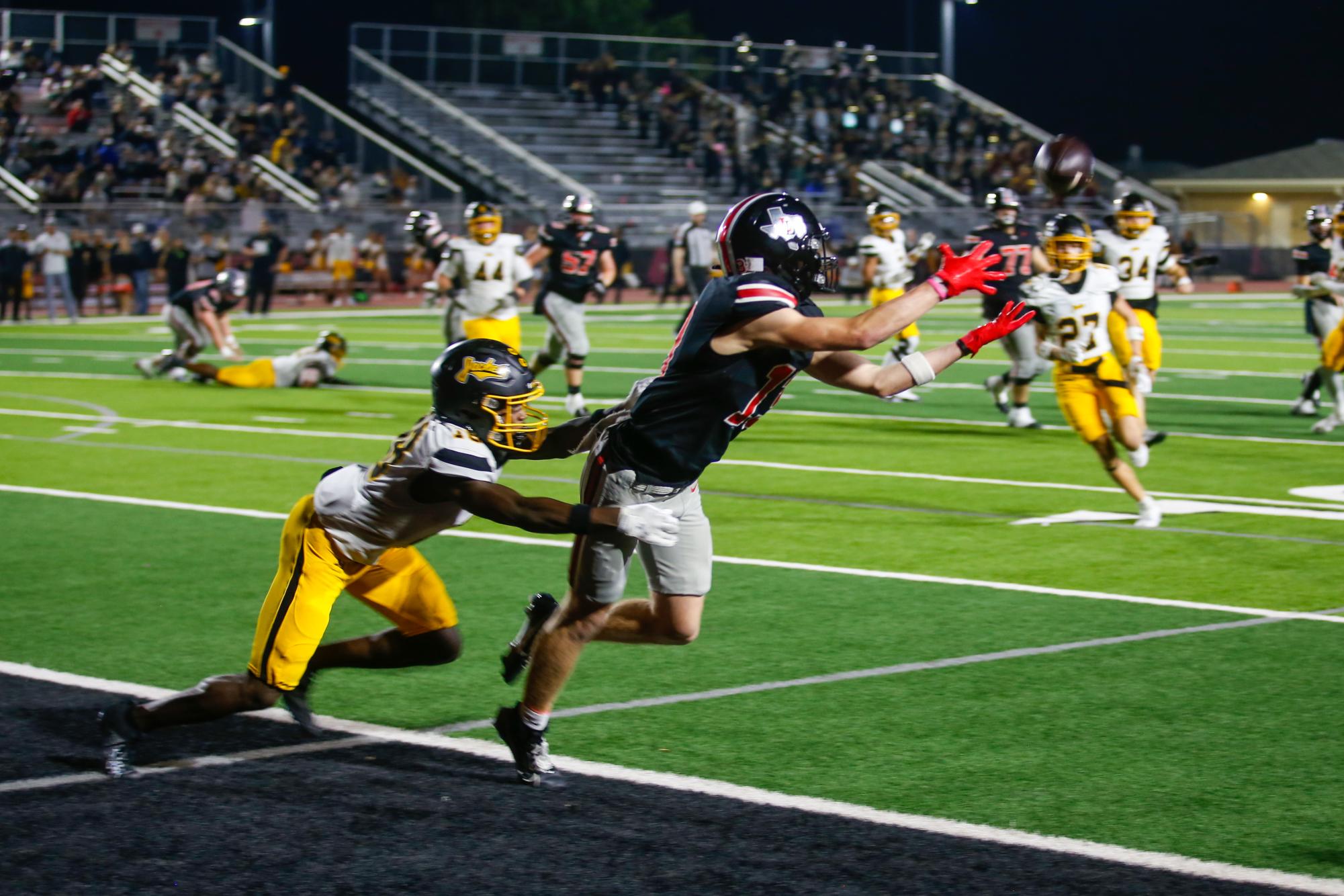 Senior wide receiver no. 13 Zane Kuzenski goes to catch a touchdown pass. Lovejoy is 6-1 in district.