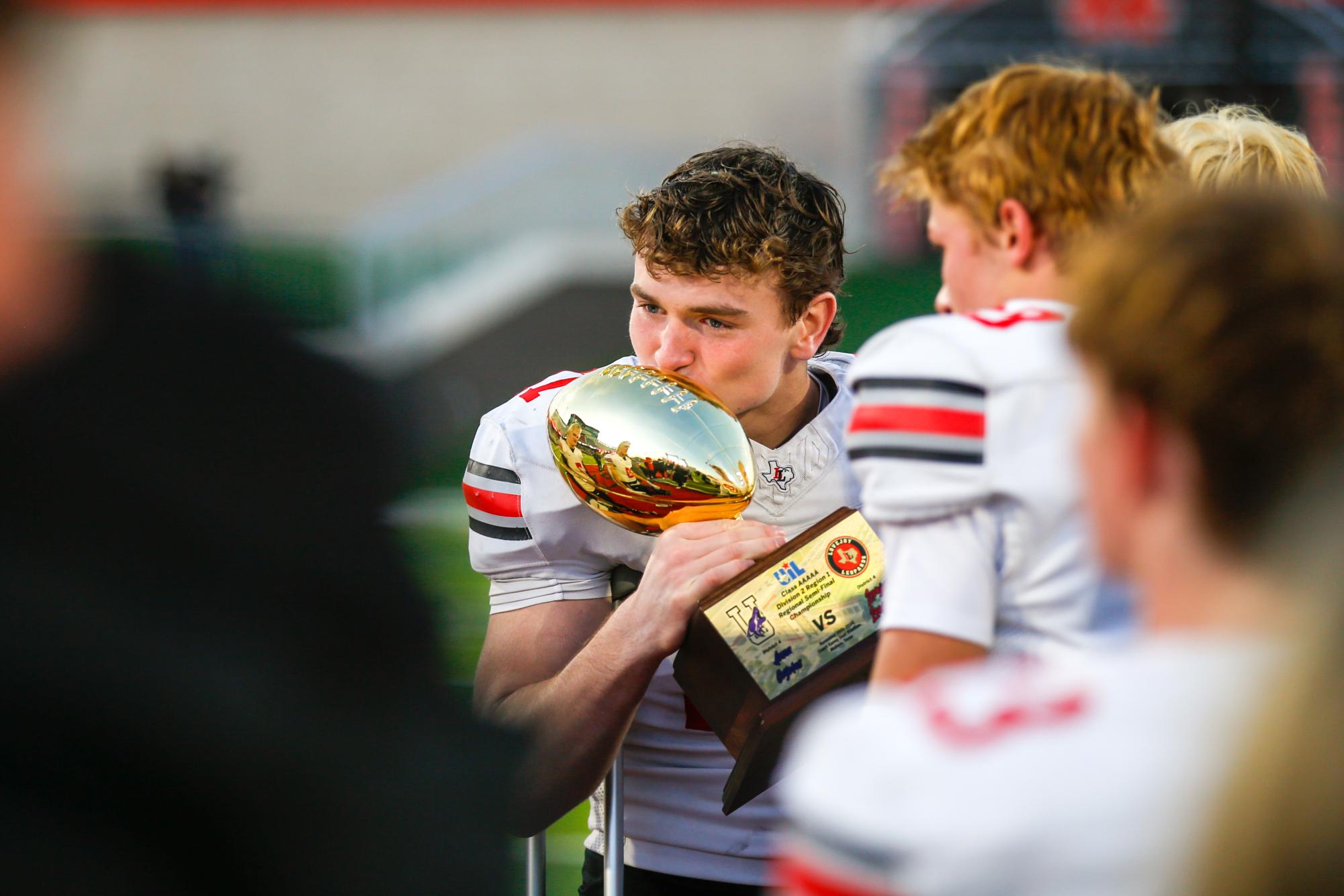 Senior linebacker no. 17 Kevin Magee kisses the trophy. Lovejoy will play Argyle high school next Friday. 