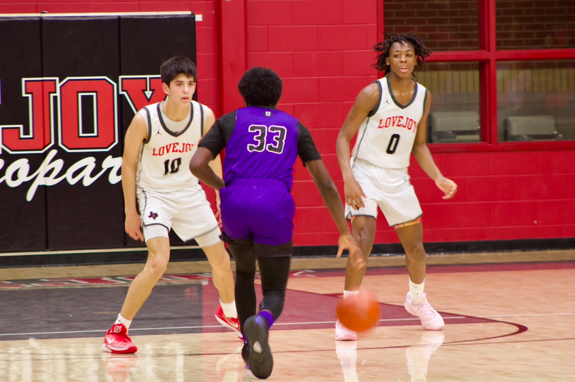 Senior guard no. 10 Pierce Patel and sophomore guard no. 0 Alex Cheatam prepare to guard an Anna player. Lovejoy is 11-1 in district.