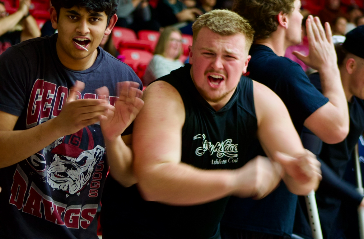 Senior Braedon Gibson gets the crowd excited for the game. The student section has nicknamed themselves "the sixth man."