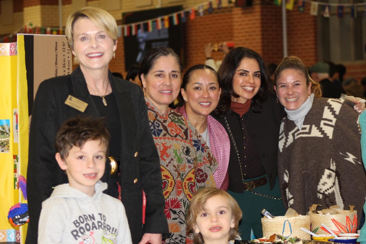 Superintendent Katie Kordel poses with volunteers at Taste of Culture. People from across the community joined together.