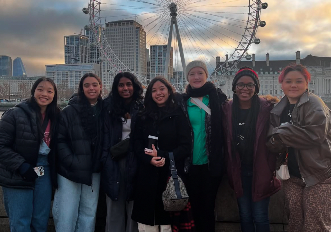 Orchestra poses in front of the London Eye. They visited London for a week.